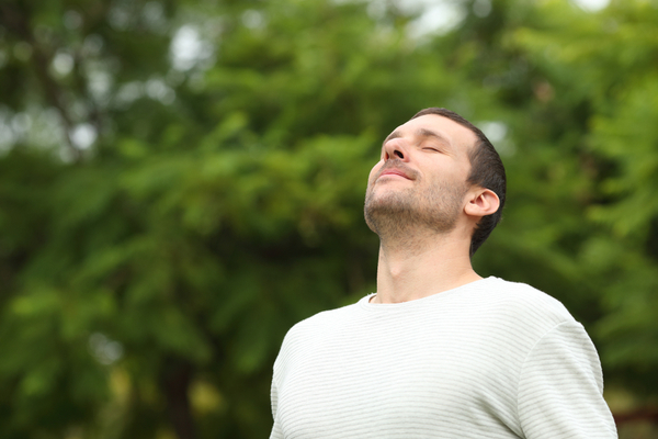 man breathing outdoors