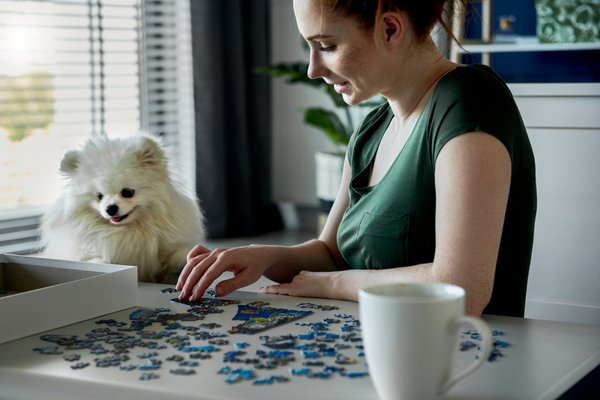 A woman doin a puzzle