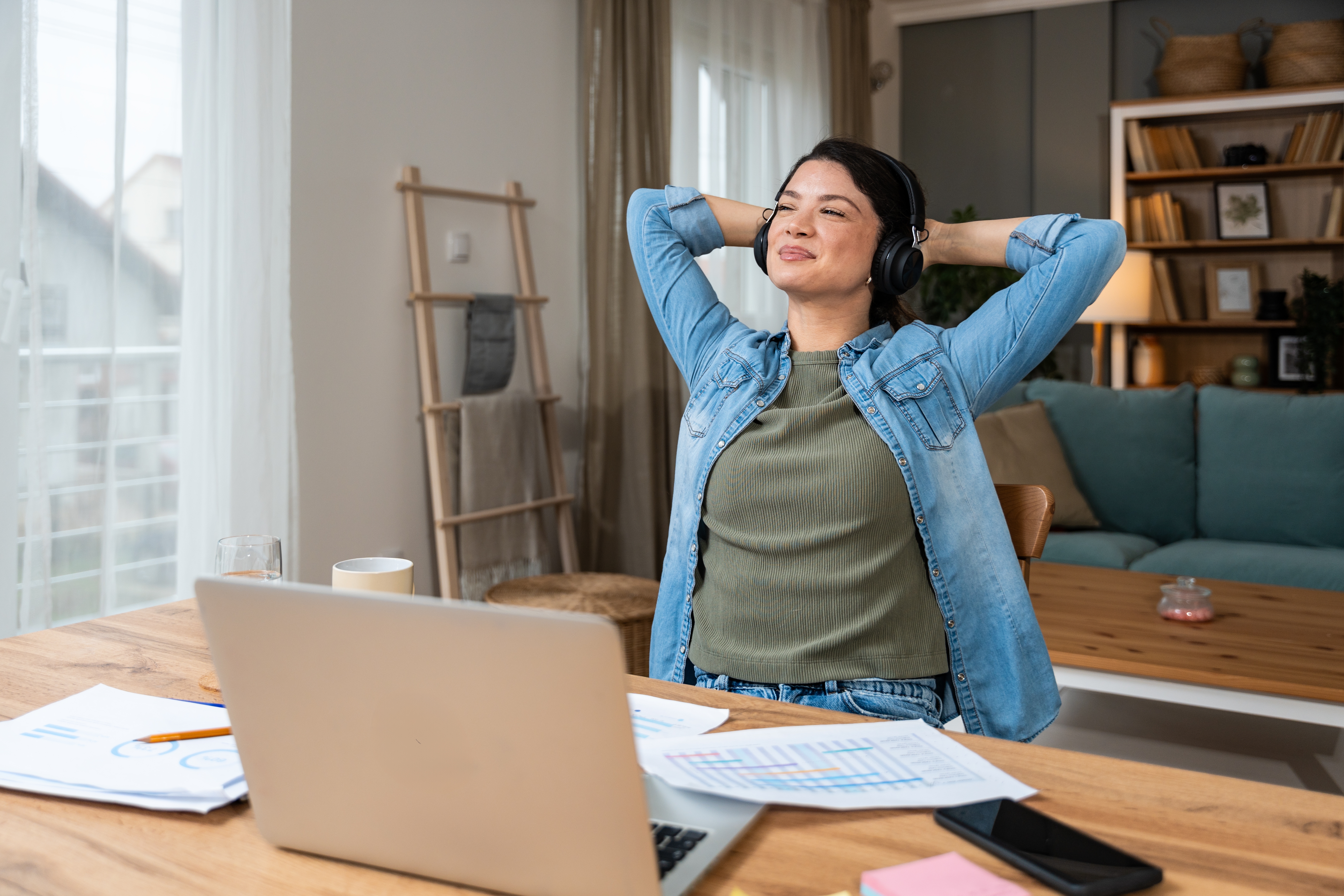 woman stretching at desk after relief from low back pain